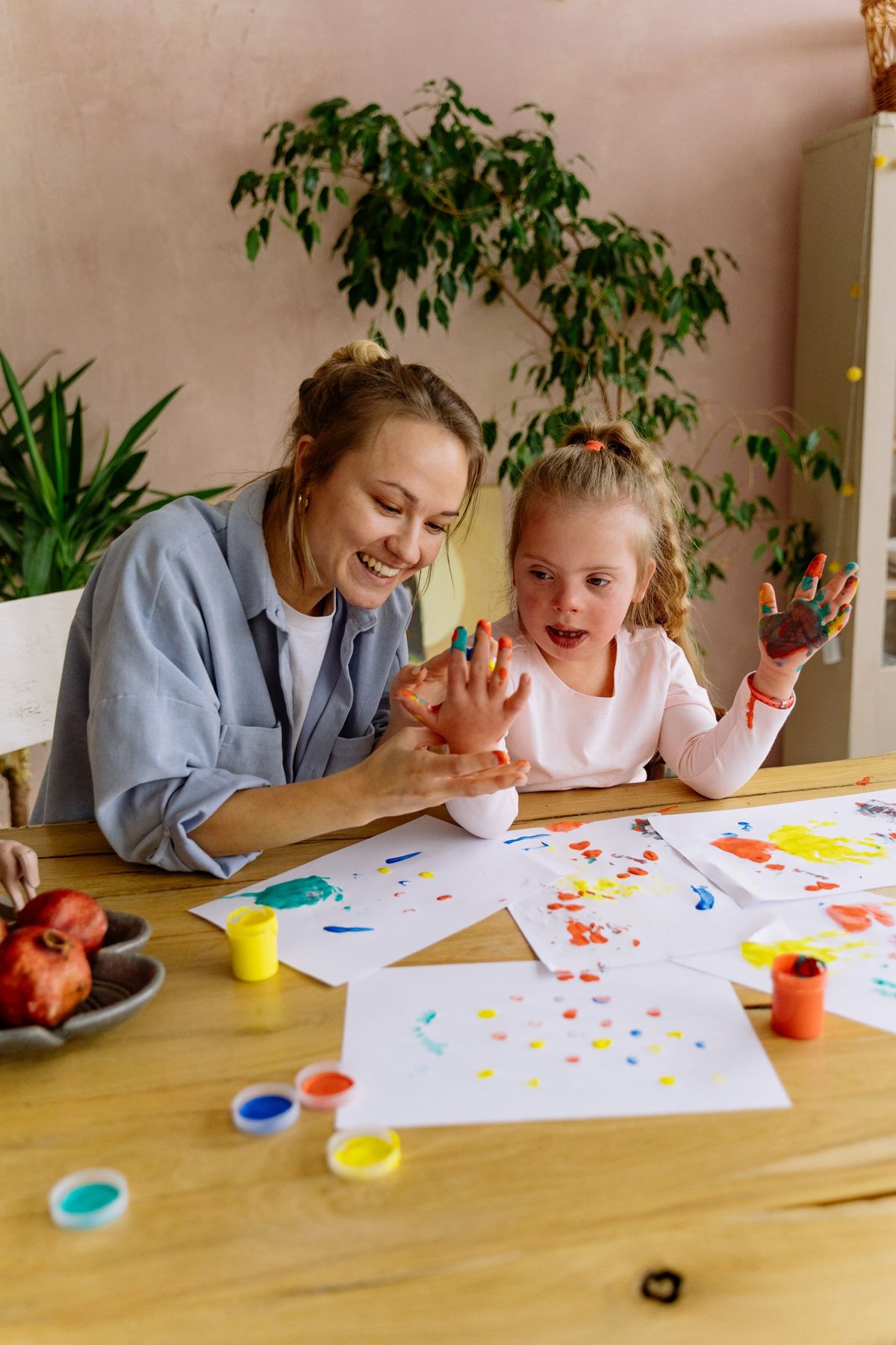 A mother and daughter painting together at home